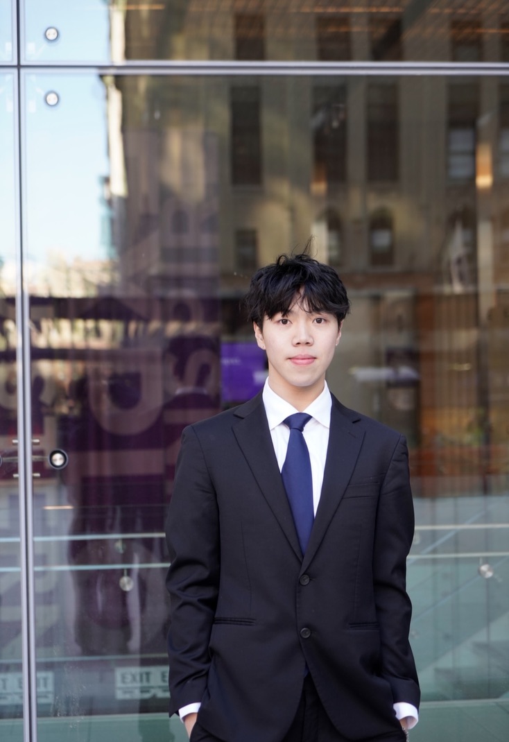 Kason Lin in a suit outside NYU Stern